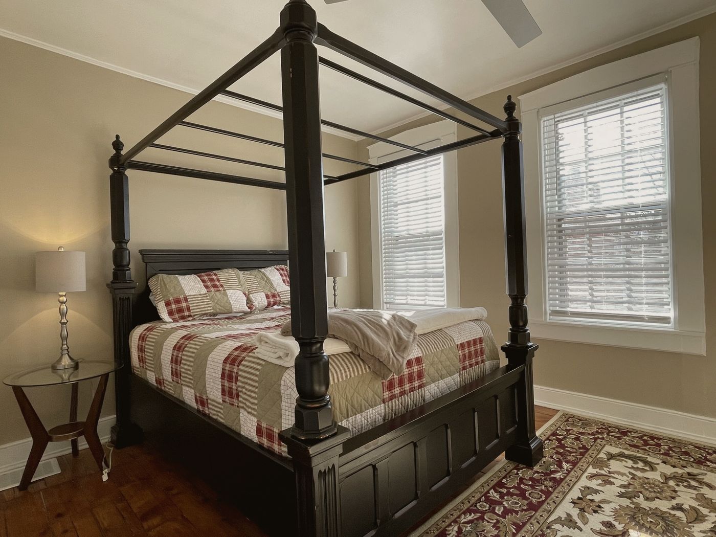 Private room with a black four-poster bed and shuttered windows